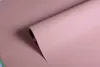 A roll of pink paper unfurling. Produktbild-Vorschau