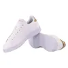 A pair of white Adidas Advantage sneakers with gold accents, shown on a white background. Podgląd zdjęcia produktu