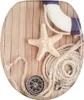 A toilet seat with a maritime-themed design featuring a life preserver, starfish, rope, and compass on a wooden background. Náhled obrázku produktu