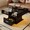 A modern black lift-top coffee table with storage, placed in a living room setting with a brown leather sofa in the background. Voir les images du produit