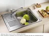 A stainless steel kitchen sink with a faucet, containing cauliflower and Romanesco broccoli, with a cutting board and garlic in the background. Náhľad obrázku produktu
