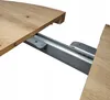 A close-up view of a table extension mechanism, showing the wooden tabletop and the metal sliding rails. Produktbild-Vorschau