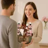 A man is handing a gift basket to a woman. Podgląd zdjęcia produktu