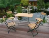 A garden furniture set is placed on a wooden deck next to a pond with a small gazebo in the background. Produktbild-Vorschau