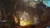 Two people are exploring a dark cave with glowing creatures and stalactites. Produktbild-Vorschau