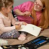 A woman and a child are drawing together in a sketchbook. Podgląd zdjęcia produktu