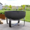 A fire pit on a wooden deck in a backyard setting with grass and plants in the background. Produktbild-Vorschau