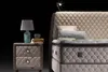 A close-up view of a bed with a nightstand. Produktbild-Vorschau