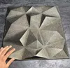 A hand is touching a 3D wall panel with a geometric design. Podgląd zdjęcia produktu