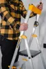A person is holding a step ladder. Náhľad obrázku produktu