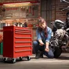 A woman is working on a motorcycle in a garage, with a red tool chest next to her. Produktbild-Vorschau