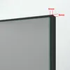 A close-up view of the corner of a mirror with black framing, showing dimensions indicated by red lines and text. Produktbild-Vorschau