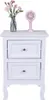 A white nightstand with two drawers, topped with a vase of pink flowers and a small pink fan. Anteprima dell’immagine prodotto