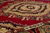 A close-up view of a red and beige patterned carpet. Náhled obrázku produktu