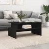 A black coffee table in a living room setting, placed on a rug in front of a sofa. Podgląd zdjęcia produktu