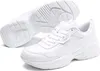 A pair of white Puma sneakers shown from a slightly elevated angle, with one shoe placed in front of the other, and the sole of one shoe visible. Produktbild-Vorschau
