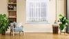 A living room scene with a chair, plants, and a window with curtains. Produktbild-Vorschau