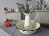 A vintage-style washbasin and pitcher set with lavender and soaps, set on a table with a polka-dot tablecloth. Produktbild-Vorschau