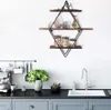 A kitchen counter with a coffee machine, a plant, and a sink, with a diamond-shaped shelf unit mounted on the wall above. Produktbild-Vorschau