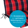A close-up of a red and blue checkered cushion with ties, featuring a blue circle overlay with German text. Produktbild-Vorschau