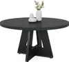 A black round dining table with a decorative base, featuring two vases with flowers and a decorative object on top. Anteprima dell’immagine prodotto