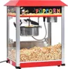 A red and silver popcorn machine filled with popcorn. Náhľad obrázku produktu