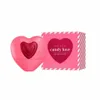A pink heart-shaped perfume bottle and its matching pink box are displayed against a white background. Podgląd zdjęcia produktu