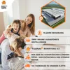 A family is playing on a bed, with marketing information overlaid on the right side of the image. Produktbild-Vorschau