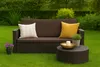 A brown outdoor sofa with cushions and a coffee table on a green lawn. Anteprima dell’immagine prodotto