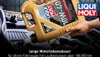 A person pouring motor oil into a car engine. Produktbild-Vorschau