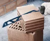A gloved hand is using a saw blade to cut a brick. The brick is placed on top of another brick. Voir les images du produit