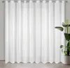 A white sheer curtain hanging in front of a window. Náhľad obrázku produktu