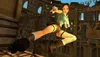 Lara Croft in action pose with guns drawn, in an ancient-looking environment. Produktbild-Vorschau