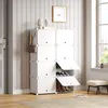 A white modular shoe rack is shown in a hallway next to a door and a window. Shoes and bags are stored in the rack. Voir les images du produit