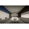 A modern office break room or common area with a long bench seat, a round table with chairs, and a kitchen counter area. Podgląd zdjęcia produktu
