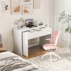 A white desk with a laptop, printer, and office supplies is set up in a bedroom next to a bed. A pink office chair is positioned at the desk. Podgląd zdjęcia produktu