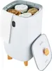 A white towel warmer bucket with rolled towels inside, a white towel hanging from the side, and the lid open to the side. The bucket has wooden legs and a digital display. Voir les images du produit