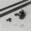A set of black curtain rods and mounting hardware laid out on a light gray surface. Podgląd zdjęcia produktu