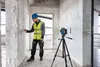 A construction worker is using a laser level in a room under renovation. Anteprima dell’immagine prodotto