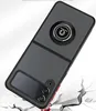 A black phone case with a ring holder is shown on a cracked white surface. Produktbild-Vorschau