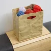 Knitterbox mit bunten Wollknäueln auf Holzregal Produktbild-Vorschau