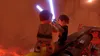 Two Lego Star Wars characters dueling with lightsabers on a platform with a fiery, lava-like background. Produktbild-Vorschau