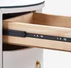 Close-up of an open drawer in a nightstand, showing the wooden interior and metal drawer slides. Voir les images du produit