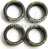 Four black tires with yellow lettering are arranged in a square formation on a white background. Anteprima dell’immagine prodotto