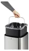 A hand is shown removing a black inner bin with a plastic liner from a silver outer bin. Podgląd zdjęcia produktu