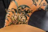 A close-up of a chair's backrest with a floral pattern. Produktbild-Vorschau