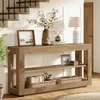 A wooden console table with decorative items and storage baskets is placed in a hallway next to a staircase. Produktbild-Vorschau