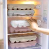 Egg holders stacked inside a refrigerator. Produktbild-Vorschau