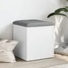 A white storage bench with a gray upholstered top sits on a wooden floor next to a white tote bag and a plant. Náhľad obrázku produktu