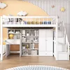 A white loft bed with integrated desk, shelves, and wardrobe, set against a light orange and white striped wall with cloud and star decorations. Podgląd zdjęcia produktu